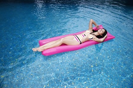 Woman floating on liloの写真素材