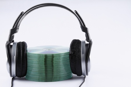 A stack of compact discs with headphonesの写真素材