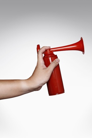 Hand holding a hornの写真素材