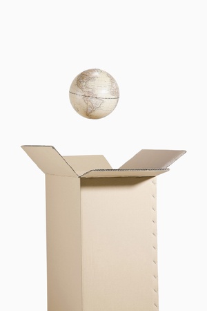 Globe floating out from a boxの写真素材