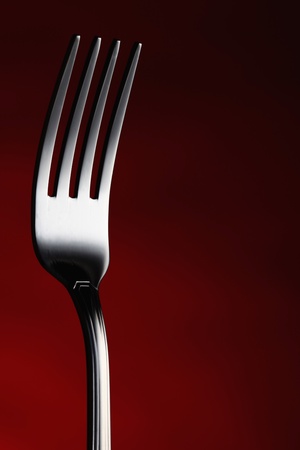 Fork utensil close up on red graduate backgroundの写真素材
