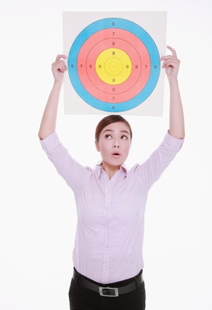 Businesswoman holding target above her headの写真素材