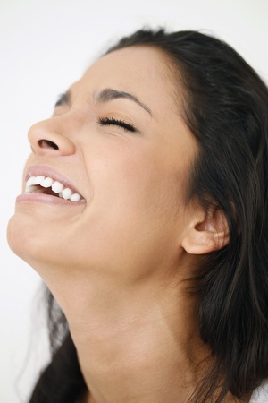 Woman laughing with her eyes closedの写真素材