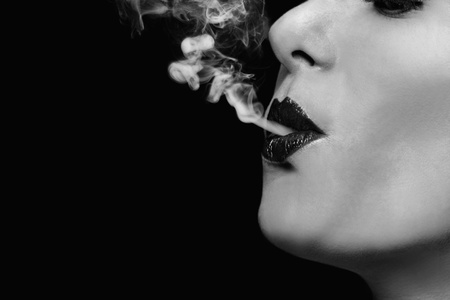 Woman blowing smokeの写真素材