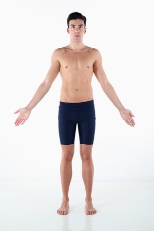Shirtless man in tights with his arms outstretchedの写真素材