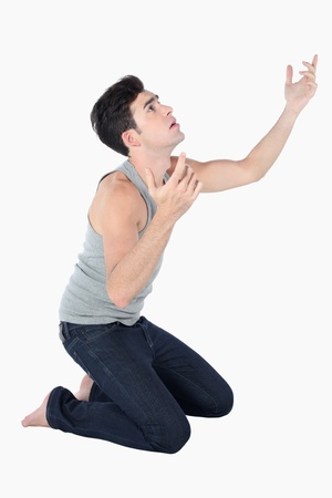 Man kneeling down and looking upの写真素材