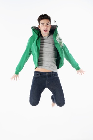 Man in hooded jacket jumping in the airの写真素材