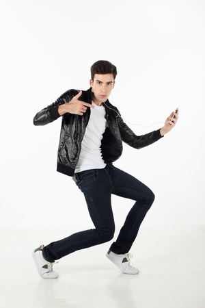 Man grooving while listening to music on MP3 playerの写真素材