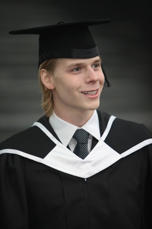 Man in graduation gown and mortarboardの写真素材