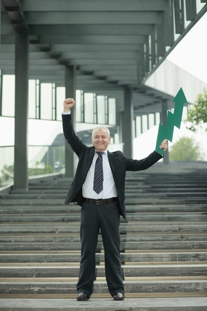 Businessman with an up pointing arrowの写真素材