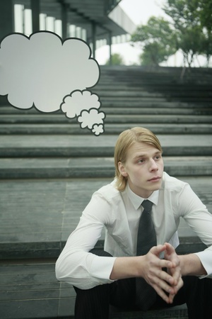Businessman with thinking bubble above his headの写真素材