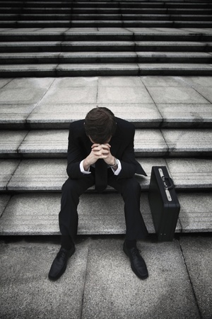  Businessman sitting on stairs looking depressedの写真素材