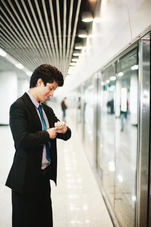 Businessman on platform waiting for trainの写真素材