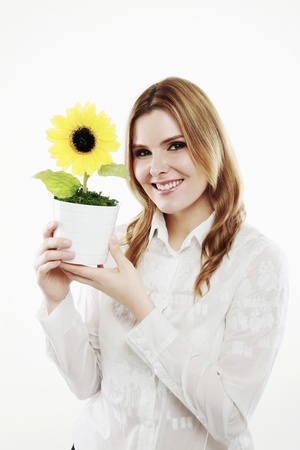 Businesswoman holding sunflower in a potの写真素材