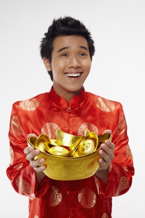 Man holding gold ingots の写真素材