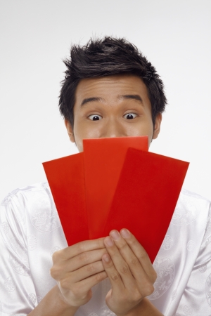 Man looking at red packets の写真素材