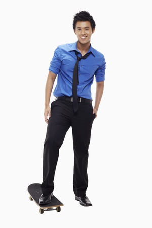 Businessman standing on skateboardの写真素材