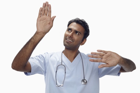 Man with stethoscope using invisible digital screenの写真素材