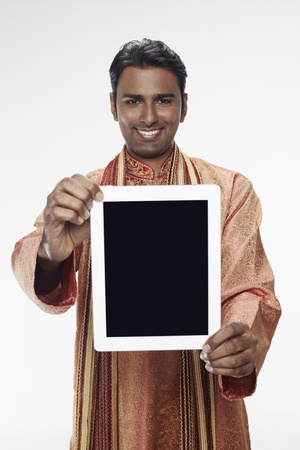 Man in traditional clothing showing digital tabletの写真素材
