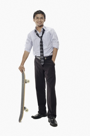 Businessman posing with a skateboardの写真素材