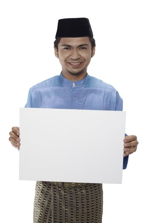 Man in traditional clothing holding blank placardの写真素材