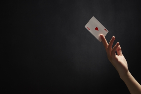 Female hand holding an Ace of Hearts cardの写真素材