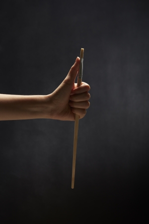 Human hand holding a paint brushの写真素材