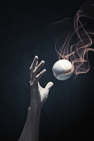Human hand catching a baseballの写真素材