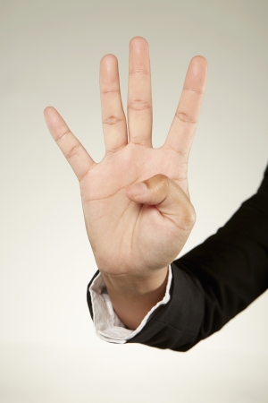 Four fingers held upの写真素材