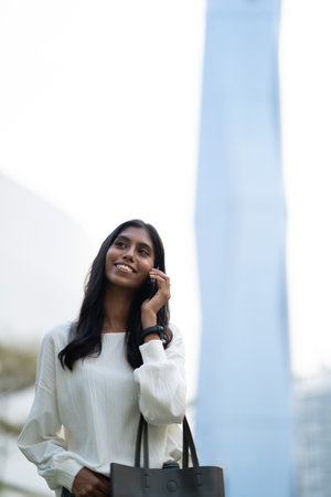 Young Indian woman talking on phone