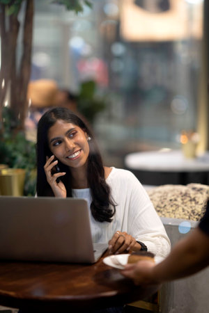 Young Indian woman talking on phone