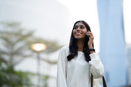 Young Indian woman talking on phone