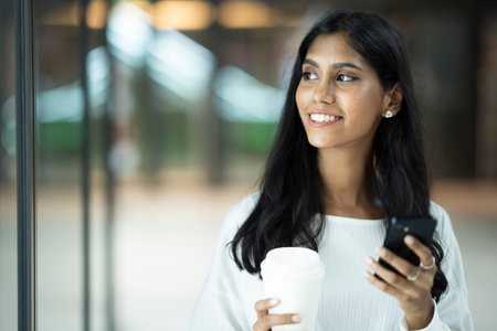 Young Indian woman with a cup