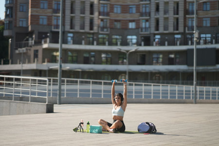 Young woman in sportswear training outdoors in the city. Healthy lifestyle concept