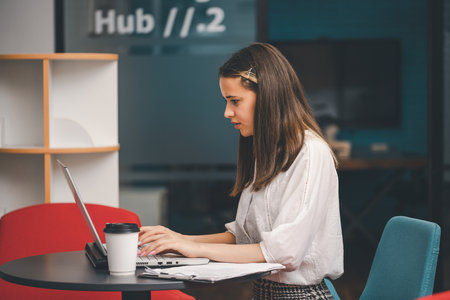 Young woman in office attire at work