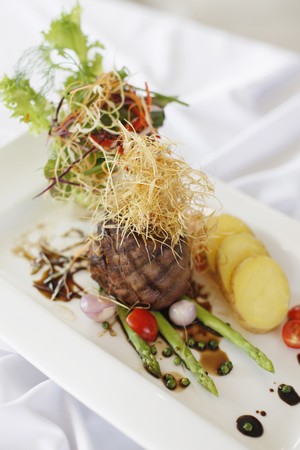 Roasted beef with sliced potatoes and asparagusの写真素材