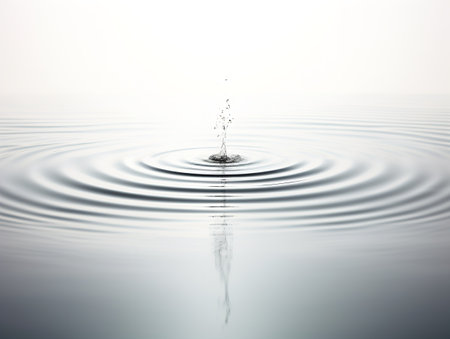 Water Droplet Creating Ripples Impact and Influence Isolated on White Background AI Generatedの素材
