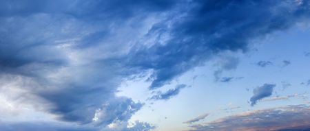 Dark sky and dark clouds. Sunset. Sun is left.