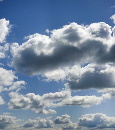 Fluffy clouds slowly fly on the sky. Silently and easy.の写真素材