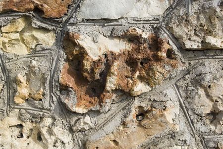 Stone laying (concrete seams). A brown rough stone (camstone).