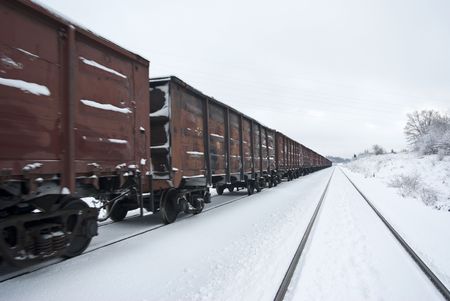 Freight train with coal (or gravel). After a plentiful snowfall. (Partly small motion blur)の写真素材