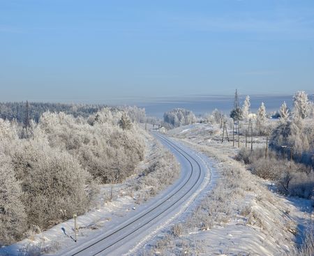 On branches plentiful hoarfrost. The shining sun shines behind. Near to small town. The railwayの写真素材