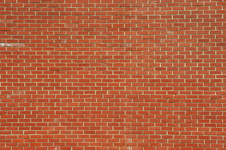 red old brick wall background for designの写真素材