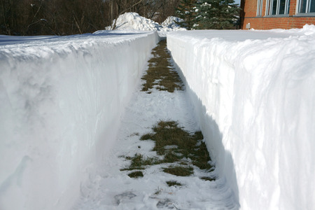 path beside building with snow removal after blizzardの写真素材