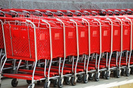 stacking red shopping cart in a rowの写真素材