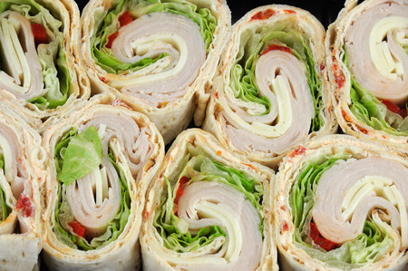 tortilla deli wrap rolls with ham vegetable isolated on white background