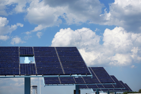 solar panels in a row in solar power station in cloudy day