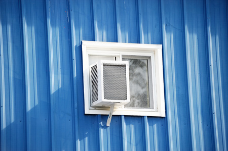 old air conditioner installed on windowの写真素材