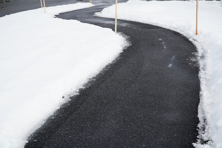 winding sidewalk after snow with snow removedの写真素材