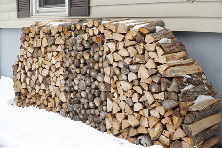 firewood stacking outside the building in winterの写真素材